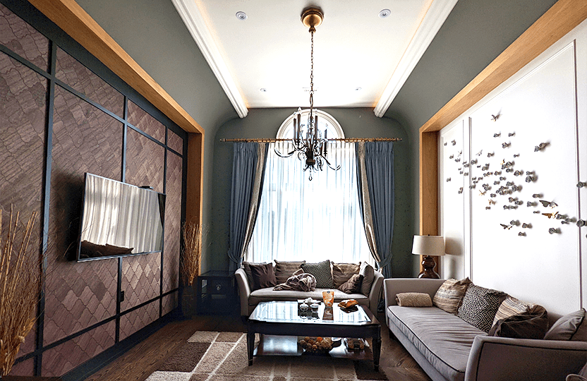Interior Home painting Project in Toronto. Where the walls are painted in a gorgeous olive green harmonizing with the golden butterfly wall decors and the wooden accent wall featuring TV
