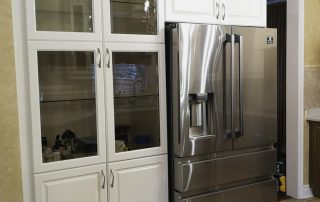 ransformed kitchen cabinets in a stunning two-toned design, painted in Benjamin Moore's Linen White OC 146 semi-gloss, and coated with a water-based satin finish varnish.