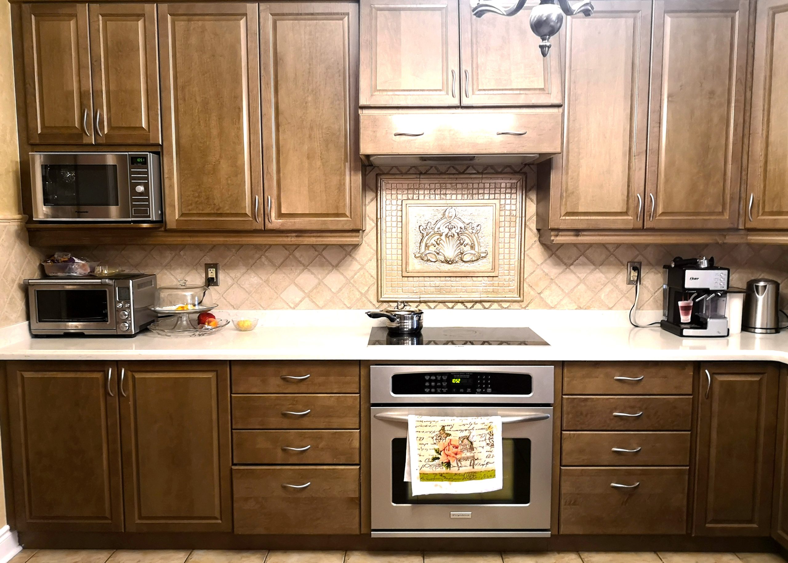 Outdated kitchen cabinets with worn surfaces, primed for a rejuvenating kitchen cabinet painting or refinishing project
