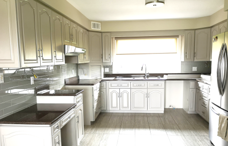 kitchenv cabinets refinished featuring a modern two-toned design, painted in Benjamin Moore's Linen White OC 146 semi-gloss and finished with a single coat of water-based varnish in satin finish