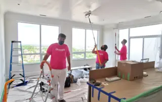Professional painting contractors from Chromatist Painters diligently paint the ceilings of a penthouse apartment in Richmond Hill, Toronto, ensuring precision and quality.