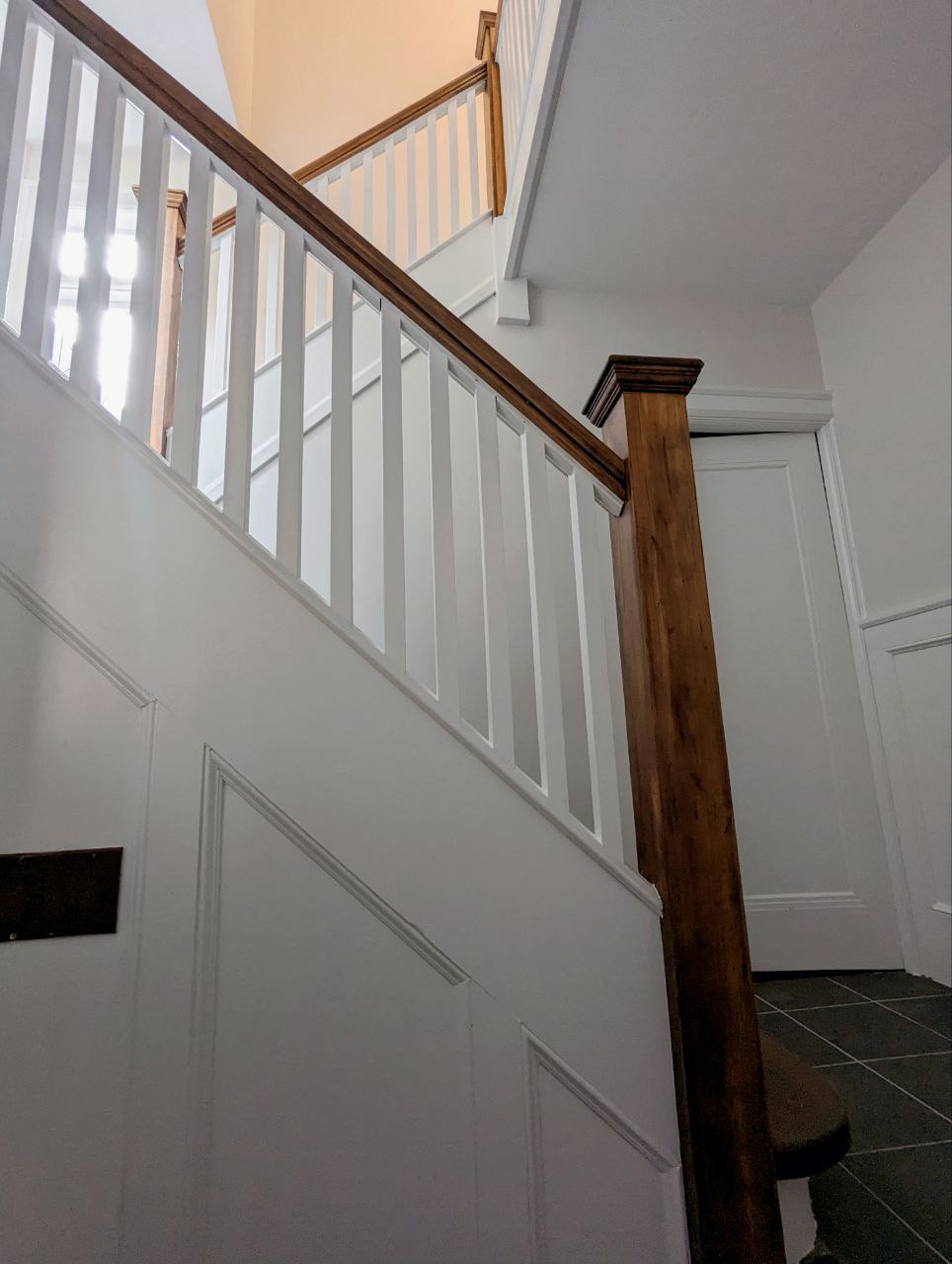Stairs Refinishing in Bennington Heights. Stairs, wall stringers, risers, handrails, pickets and all associated wooden areas including the landing on the second floor, filedl and caulk all gaps, Striped all varnish and stain, applied 1 coat of stain 2 coats of water base varnish, all areas except stairs and handrails painted white.