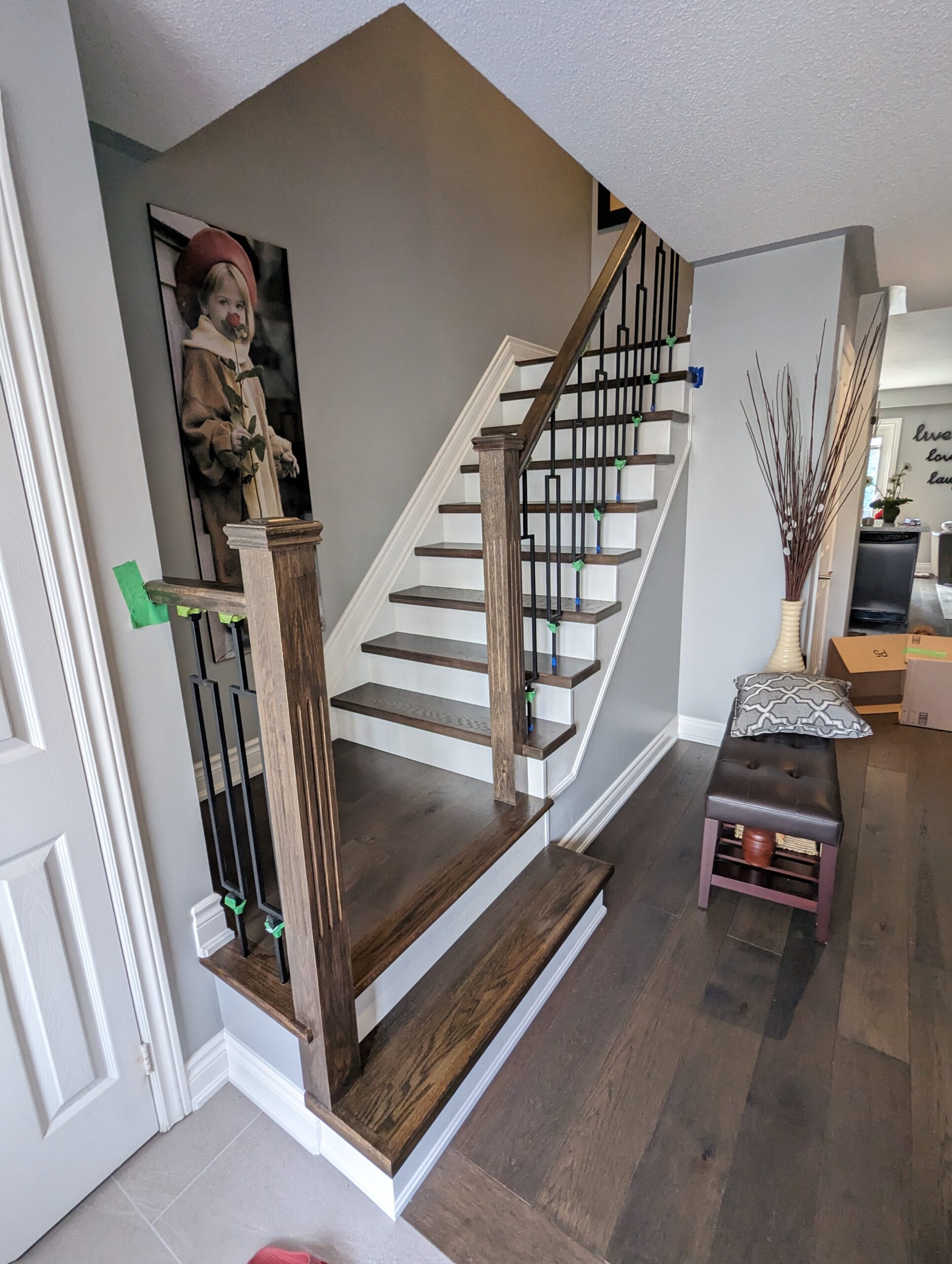 Stairs Refinishing in Markham. Stairs, wall stringers, risers, handrails, pickets and all associated wooden areas including the landing on the second floor, filedl and caulk all gaps, Striped all varnish and stain, applied 1 coat of stain 2 coats of water base varnish, all areas except stairs and handrails painted white.