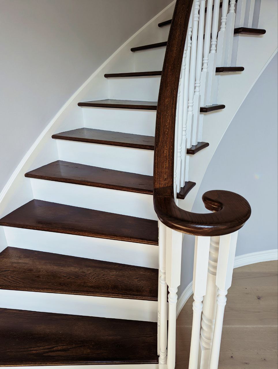 Stairs Refinishing in Oakville. Stairs, wall stringers, risers, handrails, pickets and all associated wooden areas including the landing on the second floor, filedl and caulk all gaps, Striped all varnish and stain, applied 1 coat of stain 2 coats of water base varnish, all areas except stairs and handrails painted white.