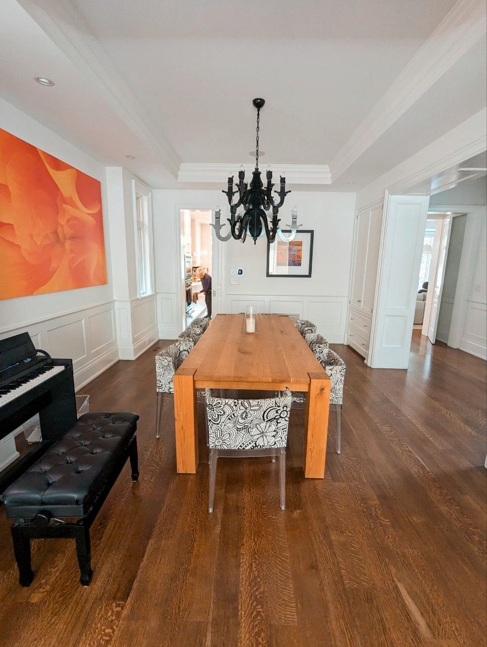 After photos of a full house painting of interior in Rosedale, experience the transformative elegance of crisp white walls baseboards, wainscoting and ceiling of a spcacious open concept bright dining room.