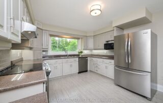 Refinished kitchen cabinets in Caledon, Ontario, showcasing the expert touch of Chromatist kitchen cabinet painting service.