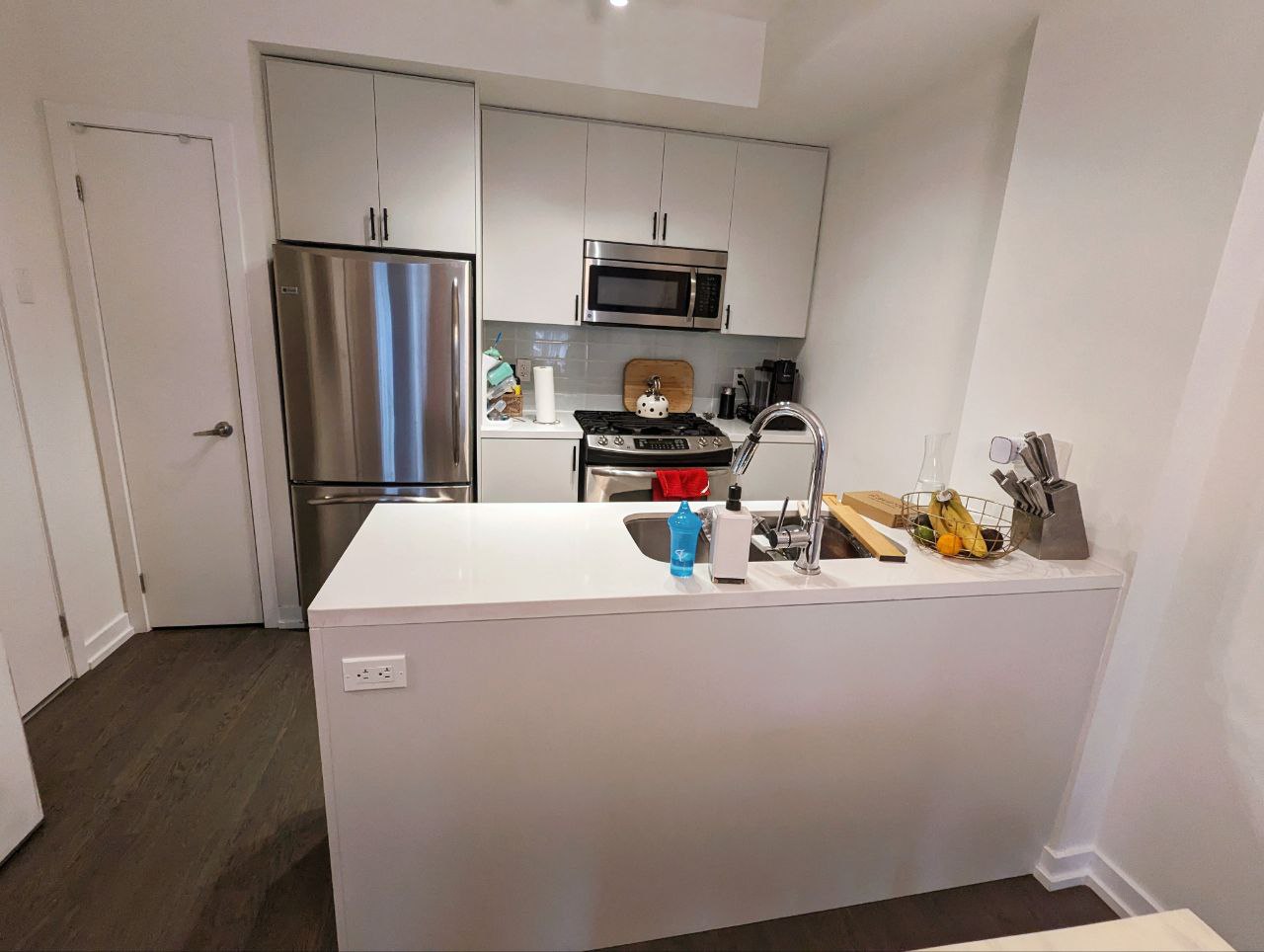 Benjamin Moore Chic Gray Owl kitchen cabinets in a cozy downtown Toronto townhome – a stunning upgrade from high-gloss slab doors. Among three kitchen cabinet paint colors suggested by our in-house color consultant, this is the client's choice and we both love it!