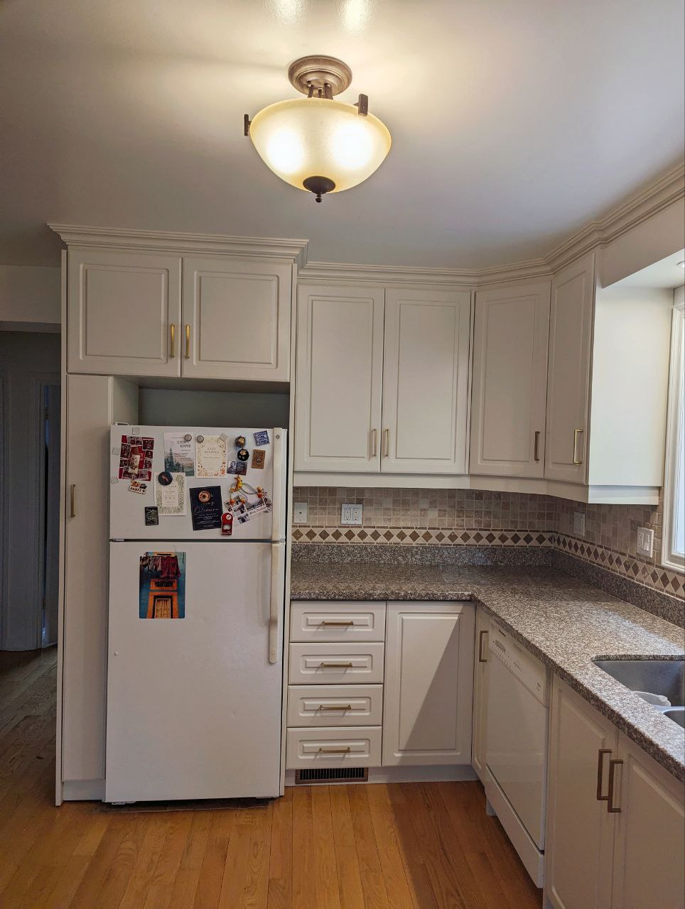 A second view of the chic Wind's Breath kitchen cabinets in a transformed Toronto bungalow. Our clients loved this kitchen cabinet paint colors suggested by our in-house color consultant.