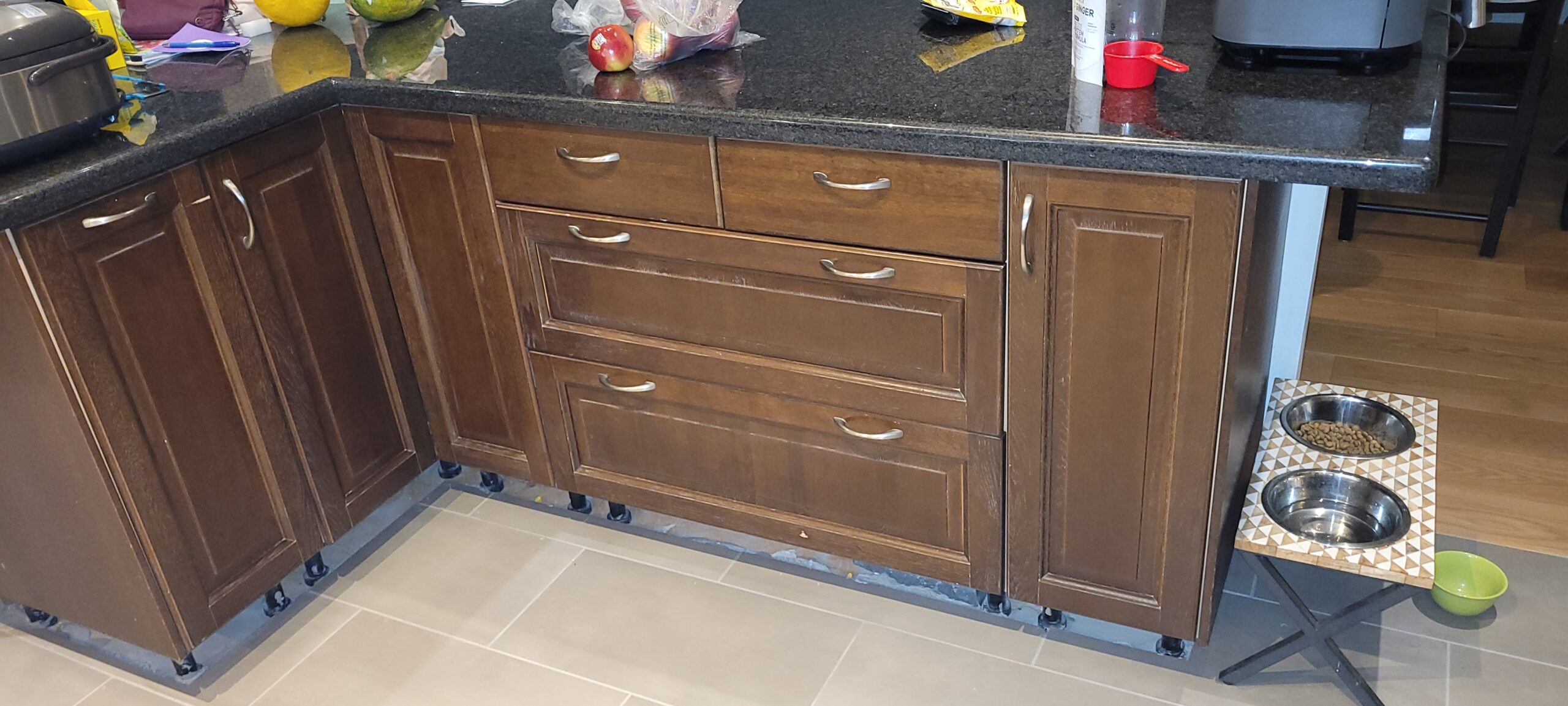 Before image of kitchen island and cabinets, showing dark wood surfaces prior to MDF cabinet painting in George Town, Toronto