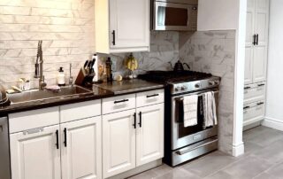 Kitchen cabinet transformation from dark wood to off-white with green undertones, MDF cabinet painting in George Town, Toronto.