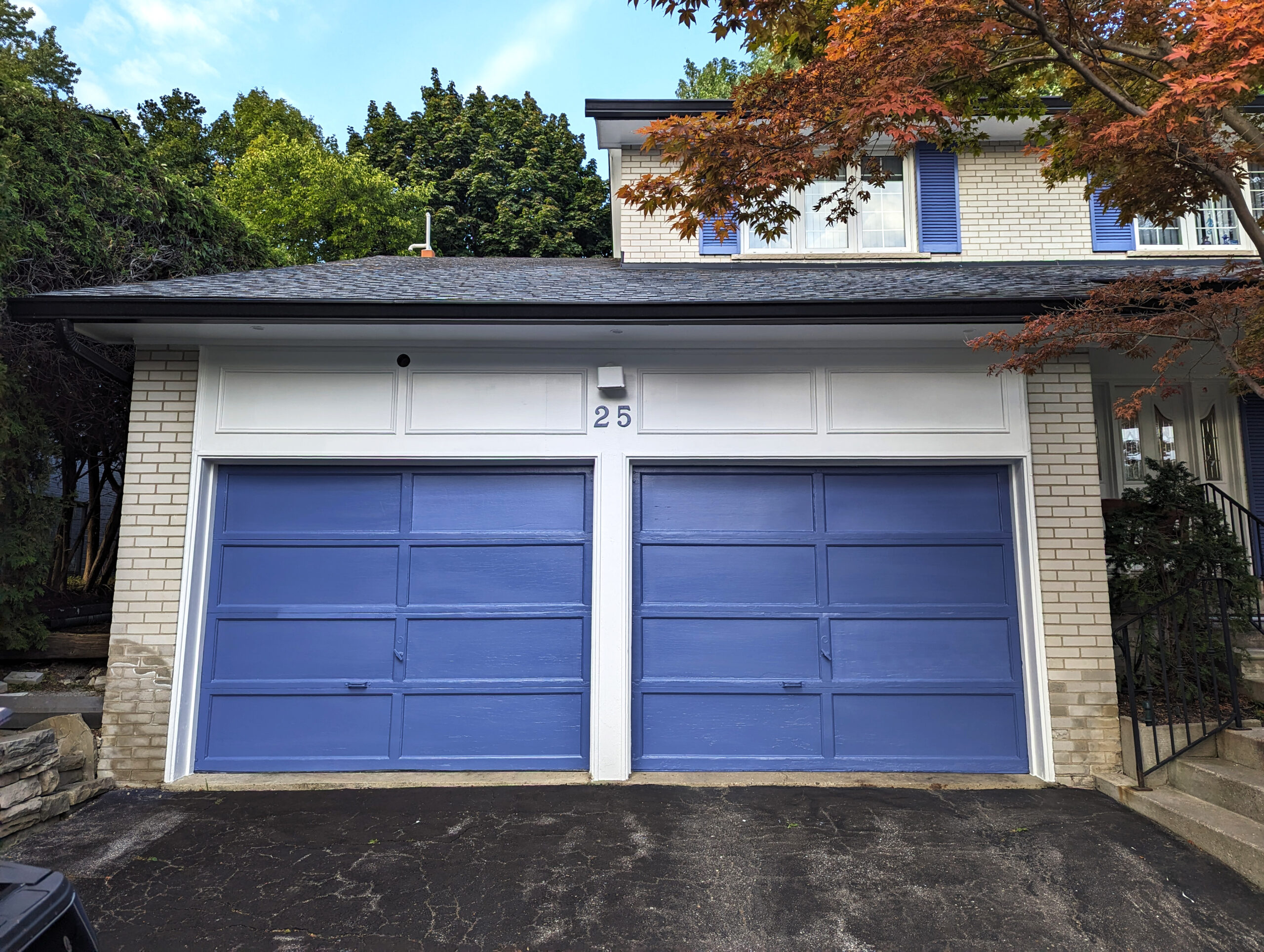 After photo of a double garage doors in North York painted in Benjamin Moore Blue Nova