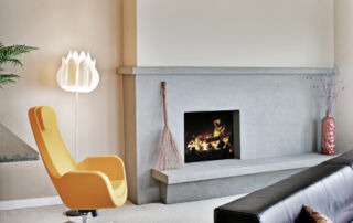 A fireplace wall in a Toronto living room featuring a sleek microcement finish, showcasing the modern and seamless aesthetic that adds a contemporary touch to the space.