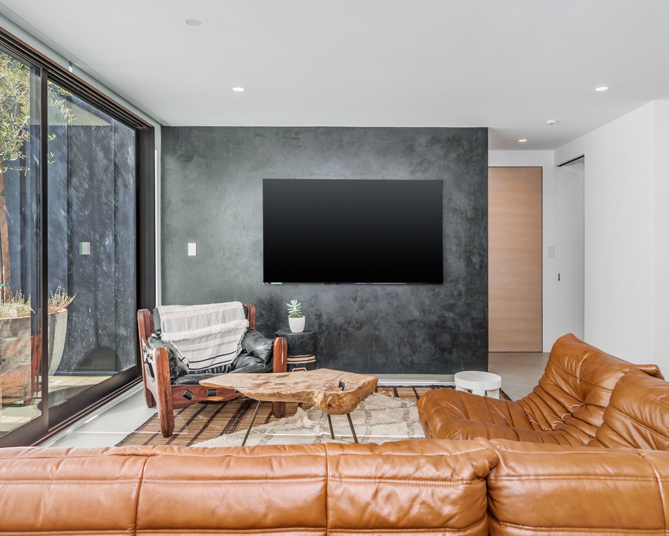 black venetian plaster on TV wall of a modern home in Leaside