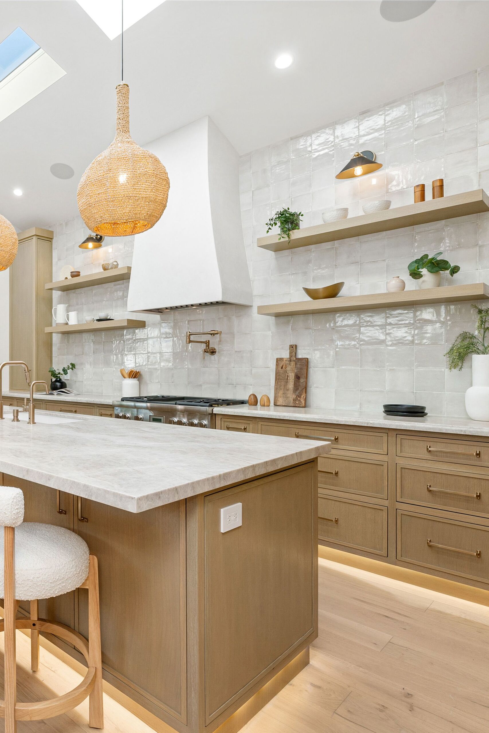 Modern kitchen with wood cabinetry and marble countertops. Marmorino Venetian Plaster Range hood kitchen finished in a warm white finish in North York.