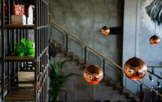 Dark gray limewash wall in a Toronto restaurant, adding texture and depth to the interior design.