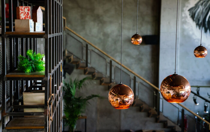 Dark gray limewash wall in a Toronto restaurant, adding texture and depth to the interior design.
