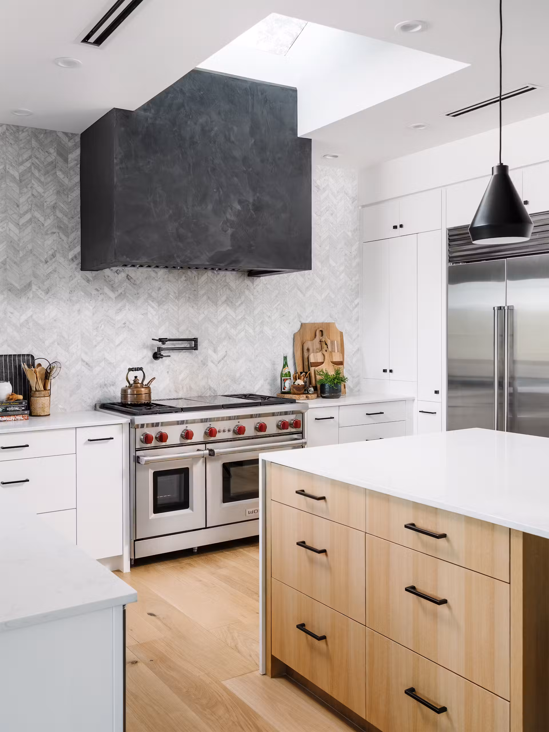 original A skylight bathes a vent hood clad in sumptuous black Venetian Plaster adding adding a pop of color and texture without over doing it.
