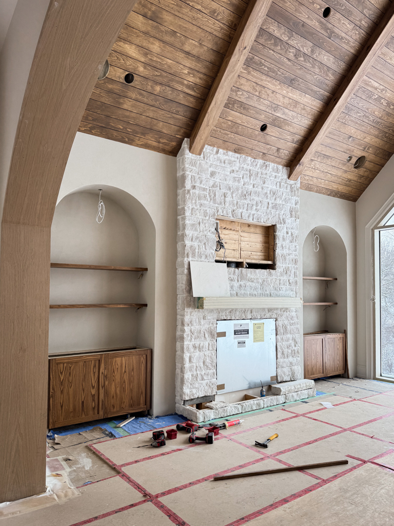 Custom great room featuring pine wood shiplap ceilings in a rich walnut stain, perfectly color-matched to modern built-in cabinetry of a media wall finished in microcement Kleinburg, Toronto.