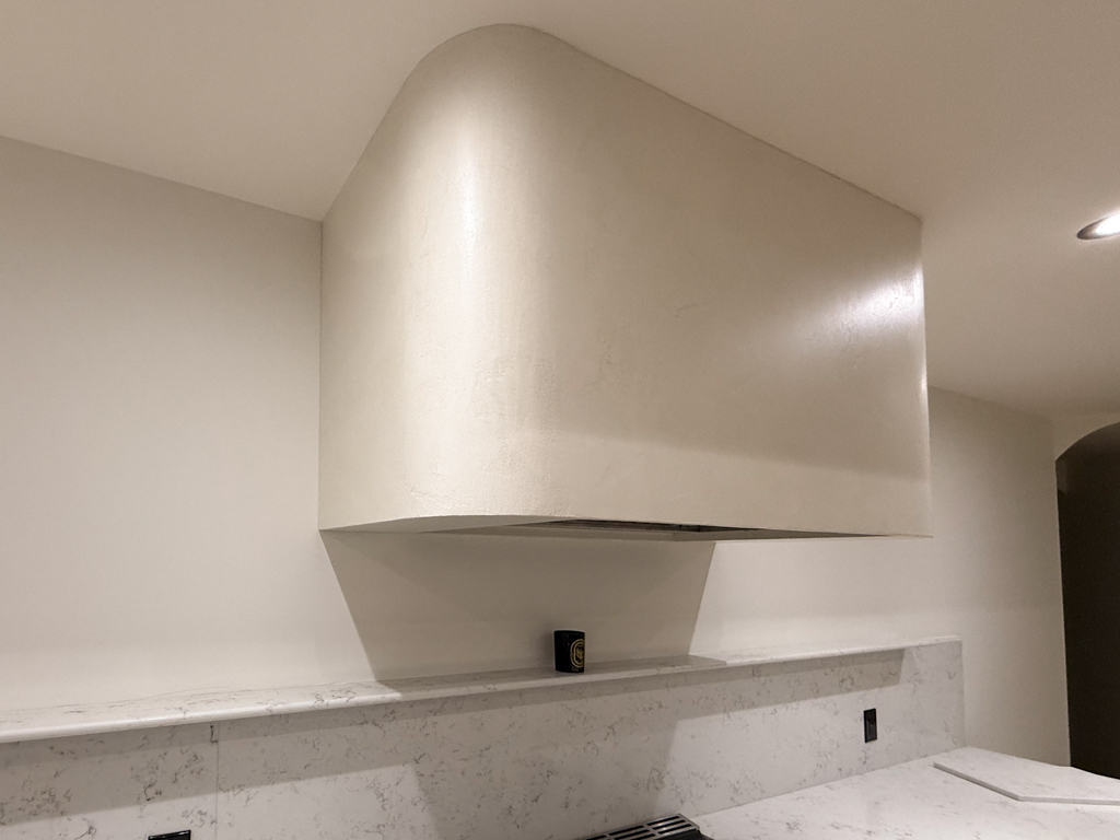 Range hood finishes: venetian plaster finish for free standing range hood, barnished soft for a soft sheen, sealed for washability, marmorino finish in off-white colour, Sherwin Williams Alabaster colour to match cabinets, venetian plaster installation project in palgrave, toronto