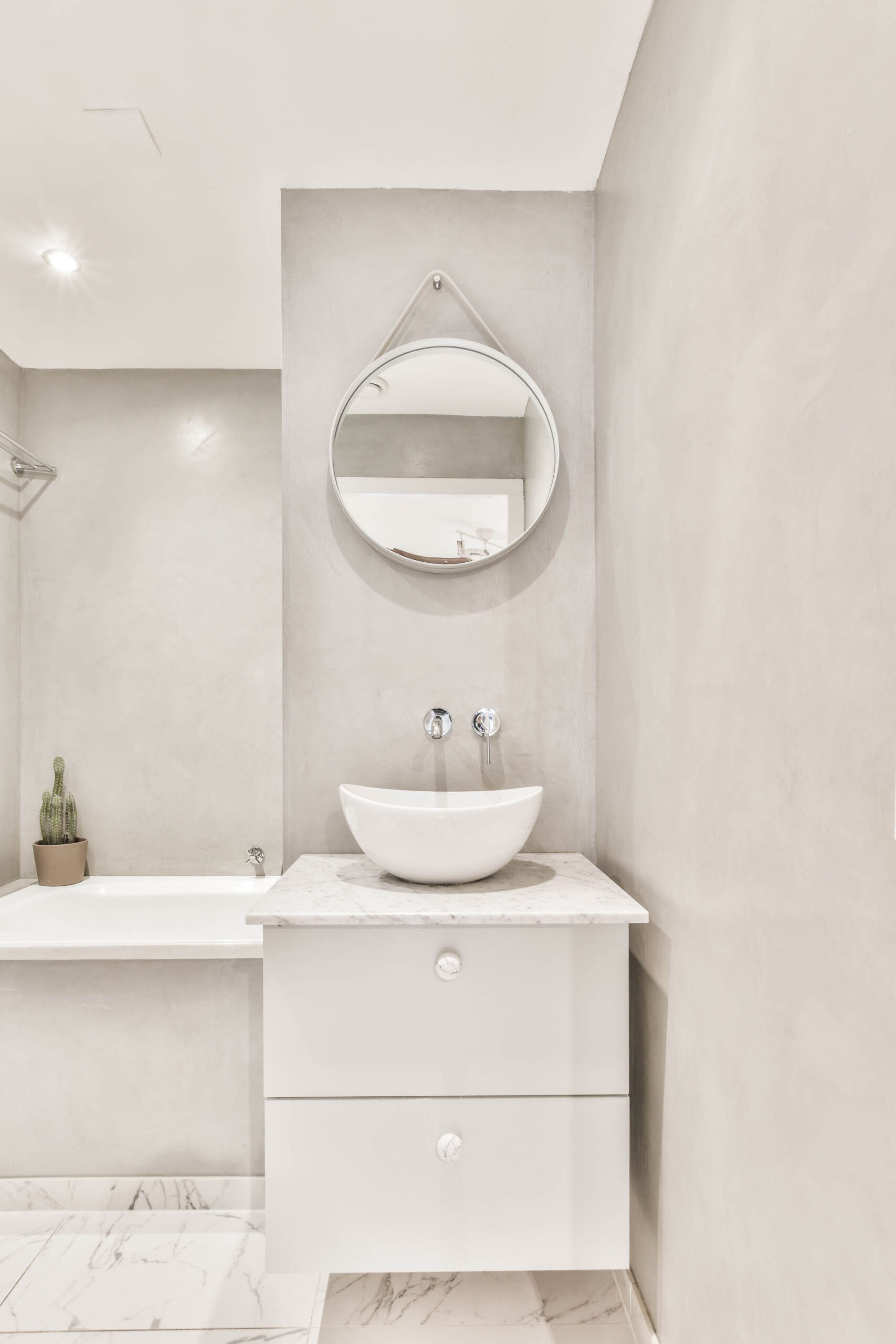 Interior of a freshly resurfaced walls, bathroom walls finished with microcement directly over tile, no demolition.