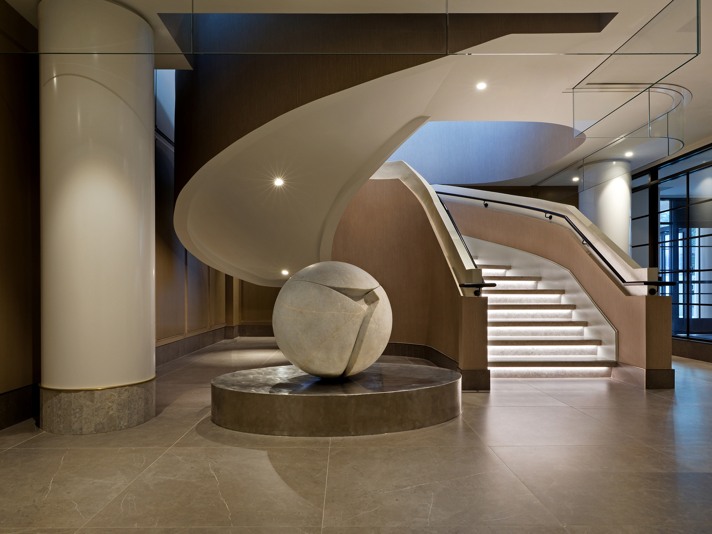 Royal-Bayview-Venetian-Plaster-Pearlescent-Handrail-Toronto Close-up of a commercial lobby staircase handrail coated in smooth, shimmering pearlescent Venetian plaster.
