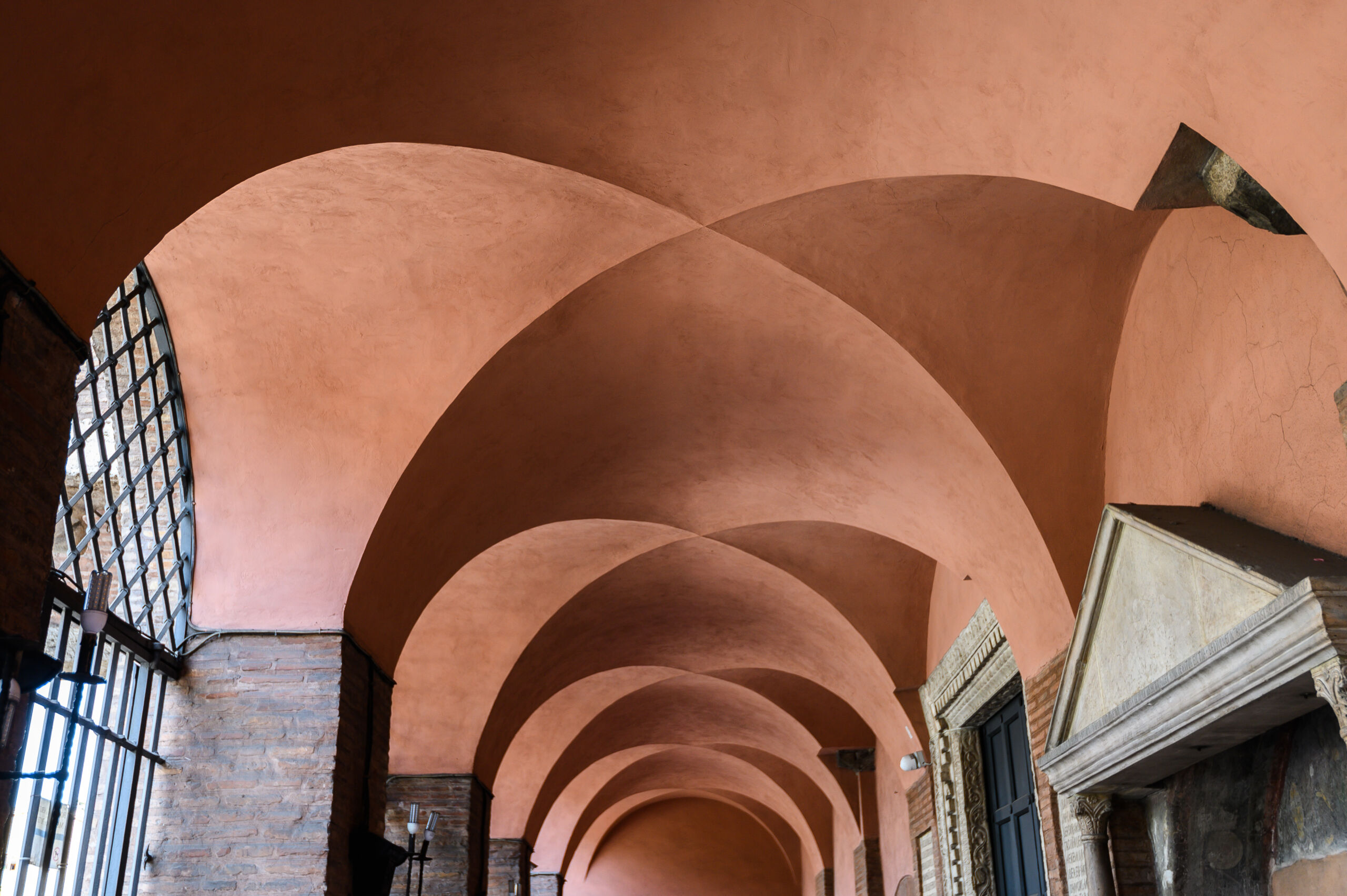 Archways of a home finished in maroon limewash clay paint