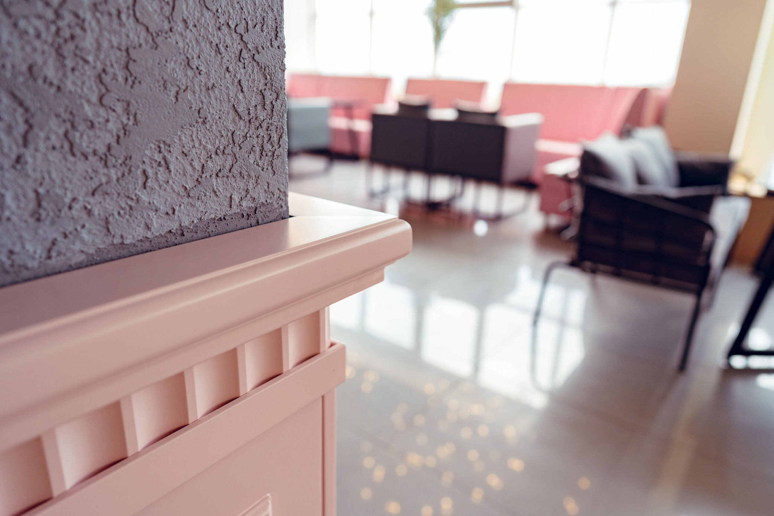 Blurred cafe interior showing tables with Venetian plaster finish walls
