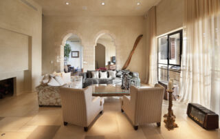 Spacious living room in a Florida home with soft creamy Roman Clay-painted walls and high ceilings.