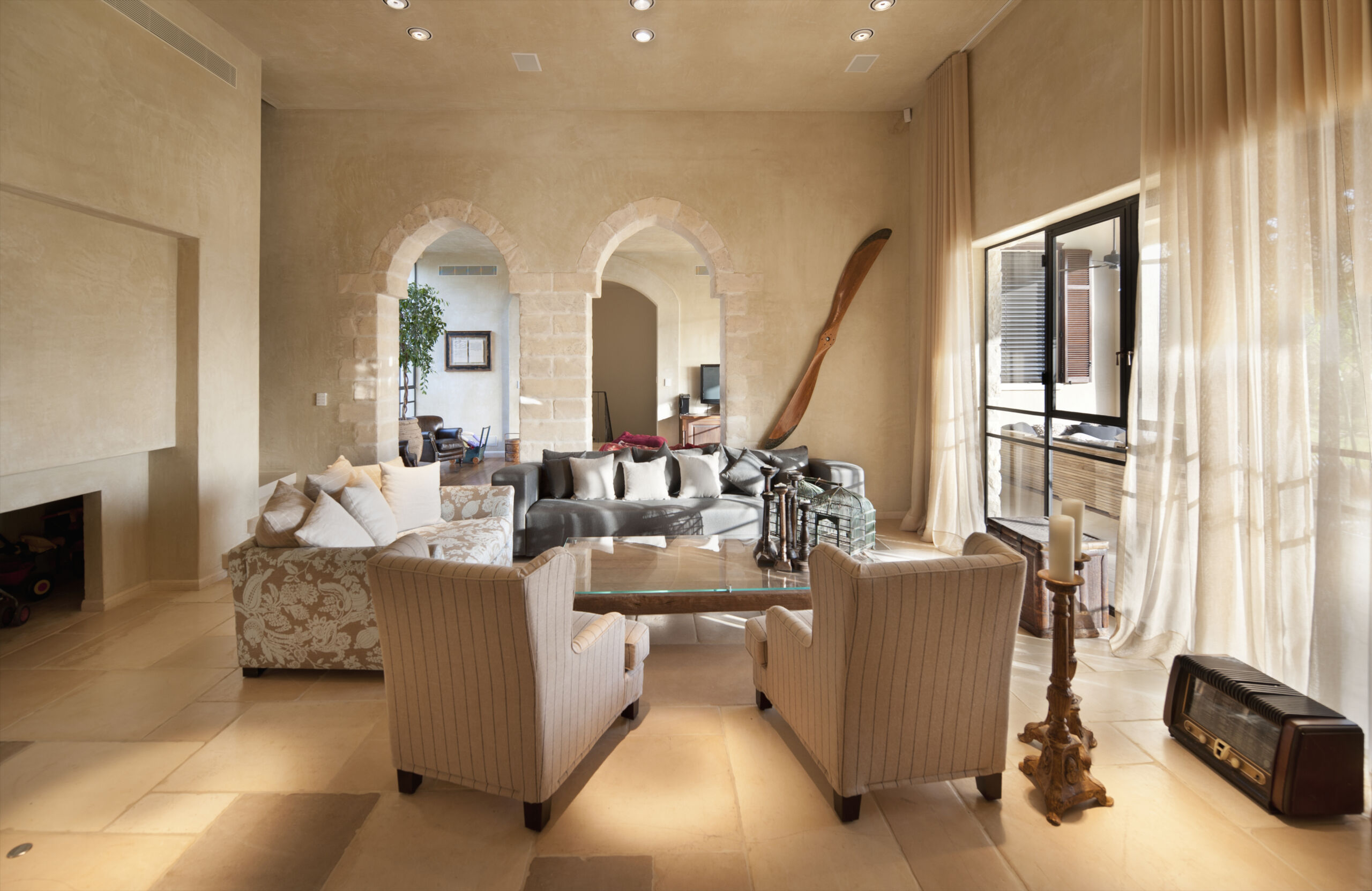 Soft Creamy Limewash Painted Living Room in Florida Home Spacious living room in a Florida home with soft creamy limewash-painted walls and high ceilings.