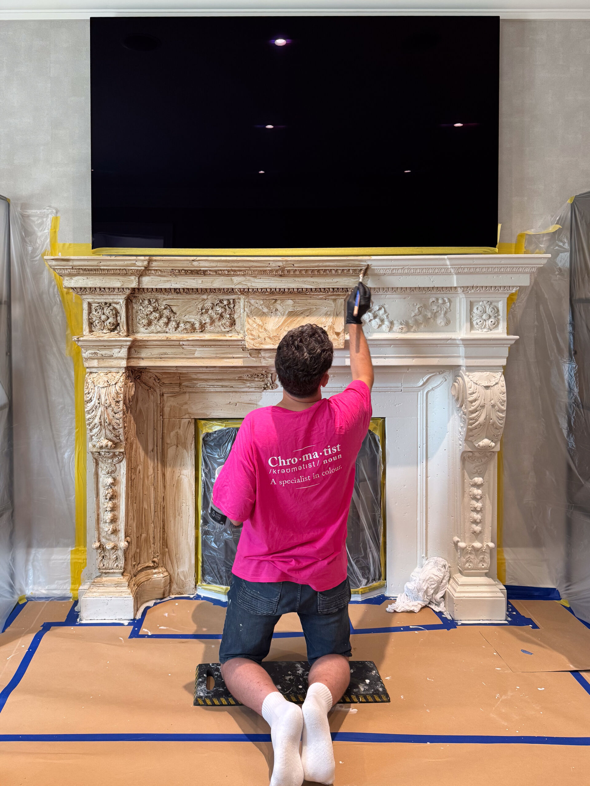 Distressed Fireplace Mantel transformation Richmond Hill Toronto13 Chromatist Painters, artisan applying antique glaze to a white-painted fireplace mantel.