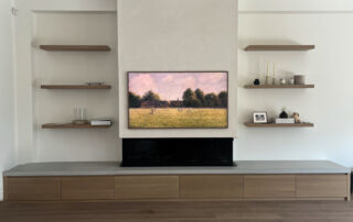 A modern white Venetian plaster fireplace, seamlessly installed in a living room in Mississauga, Toronto.
