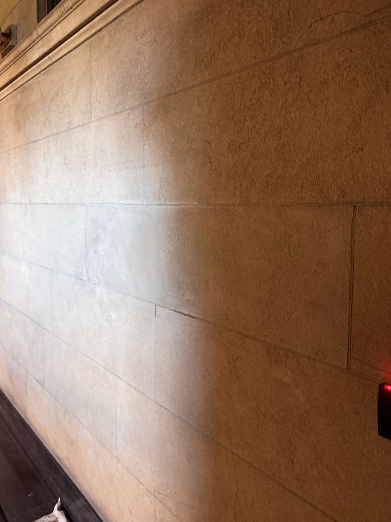 historic-plaster-repair-and-restoration-university-of-toronto-1 After photo of a fully repaired and restored historic plaster wall at the University of Toronto, showcasing a seamless and flawless plaster with natural stone finish.