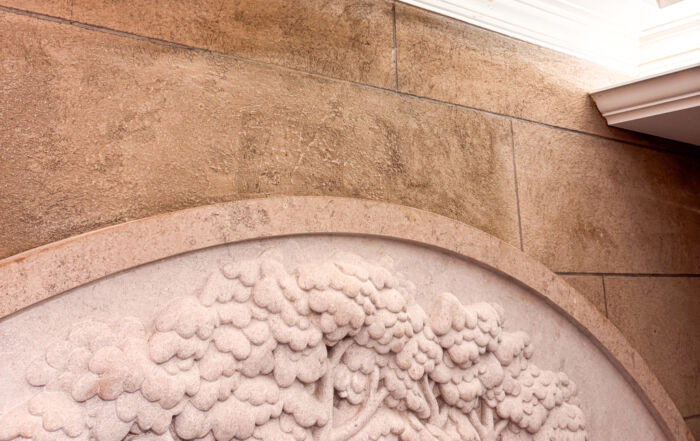 After photo of a fully restored historic plaster wall at the University of Toronto, showcasing a seamless and flawless white finish.