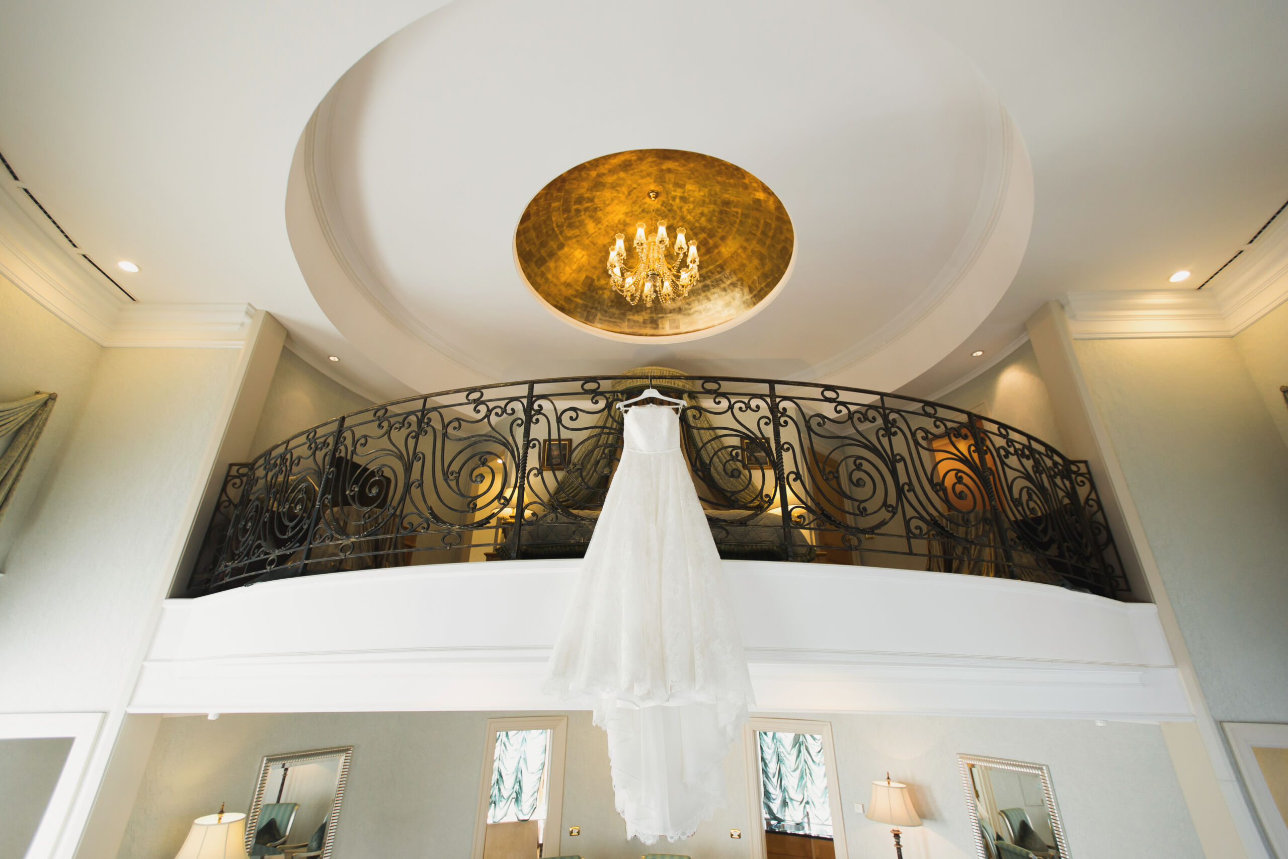 A luxurious ceiling dome finished with intricate gold leaf gilding, reflecting light and adding opulence to a classic foyer.