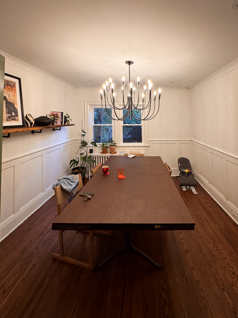 A living room in a Tudor-style home in Bloor West Village, Toronto, showing a standard painted wall before the limewash renovation.