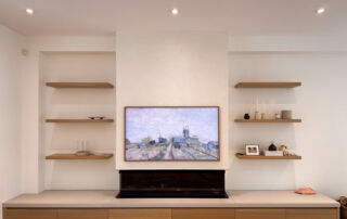 A modern white Venetian plaster fireplace, seamlessly installed in a living room in Mississauga, Toronto.
