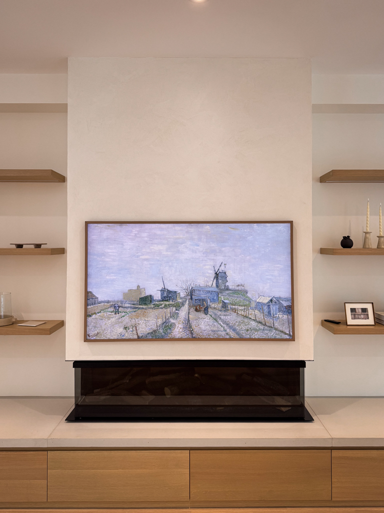 A modern white Venetian plaster fireplace, seamlessly installed in a living room in Mississauga, Toronto.