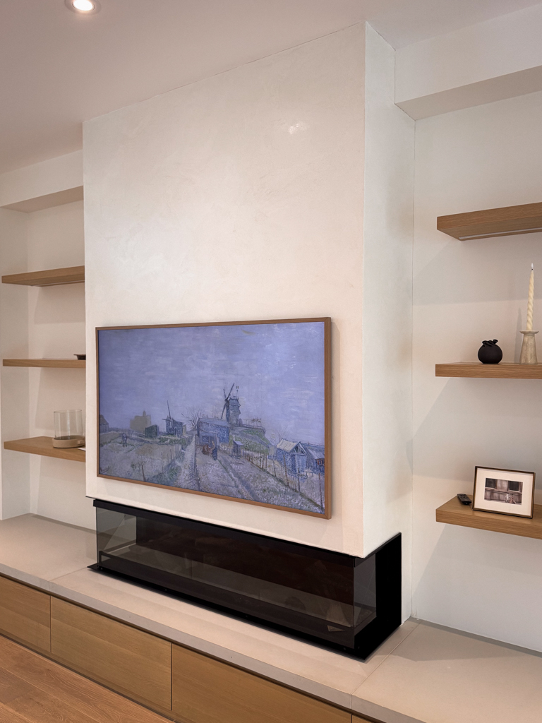 A modern white Venetian plaster fireplace, seamlessly installed in a living room in Mississauga, Toronto.