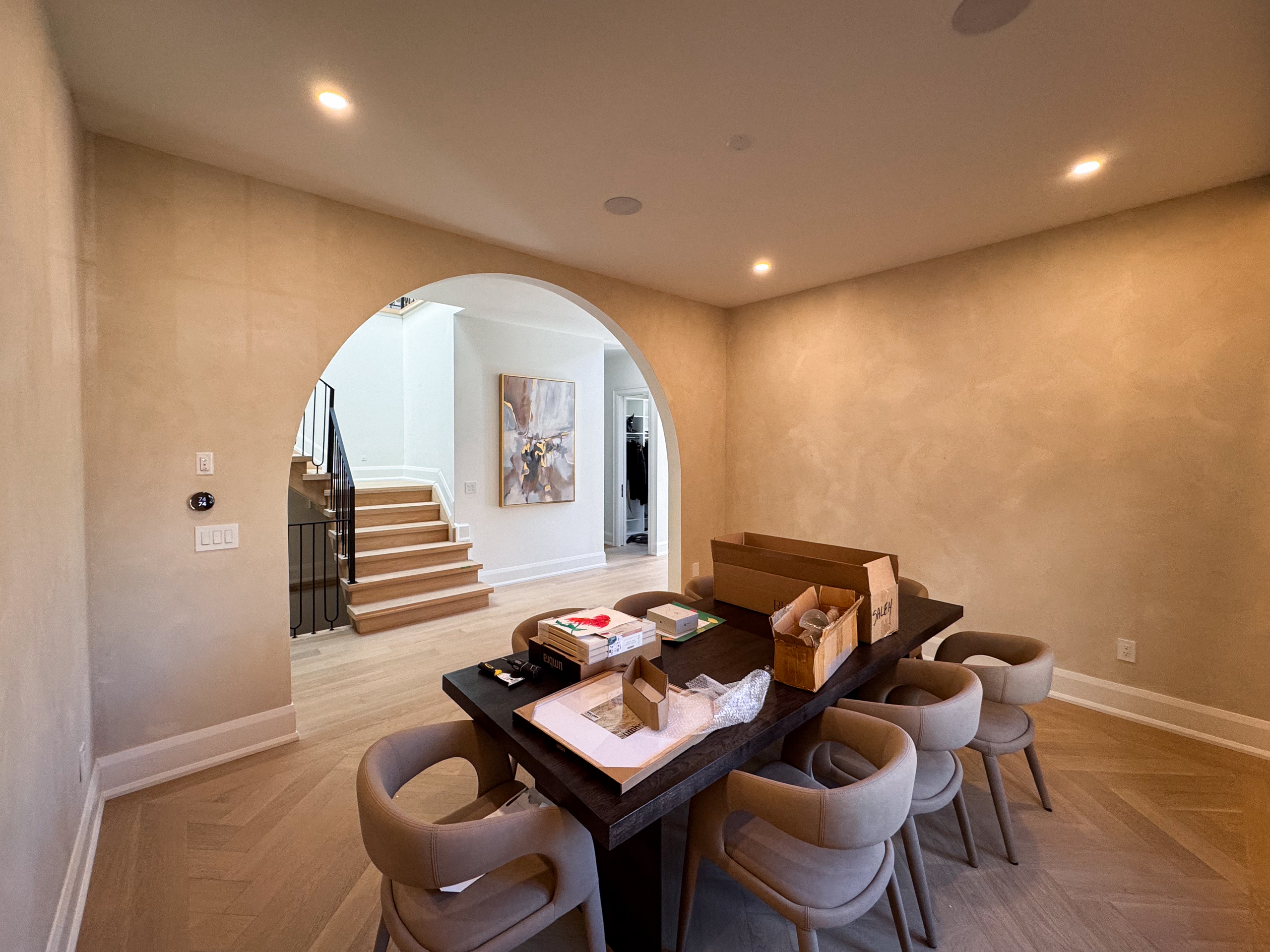 A bright Oakville interior featuring light beige limewash walls with visible brush-stroke movement, creating a textured, matte, Tuscan-style aesthetic.