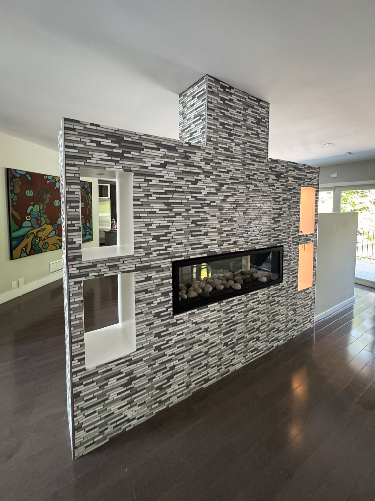Before photo of the tiled free-standing fireplace structure prior to Venetian plaster resurfacing in North York.