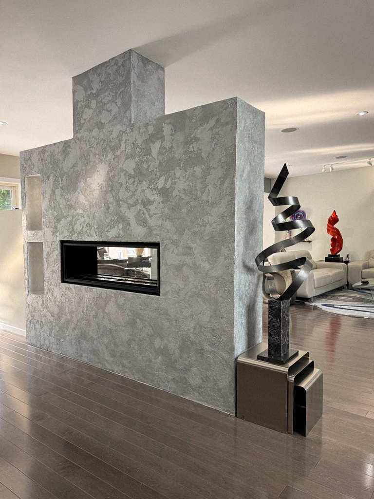 metallic-venetian-plaster-over-fireplace-wall-north york-toronto-4 Detail of the silver metallic paint and mica being applied to the final coat of the metallic Venetian plaster.