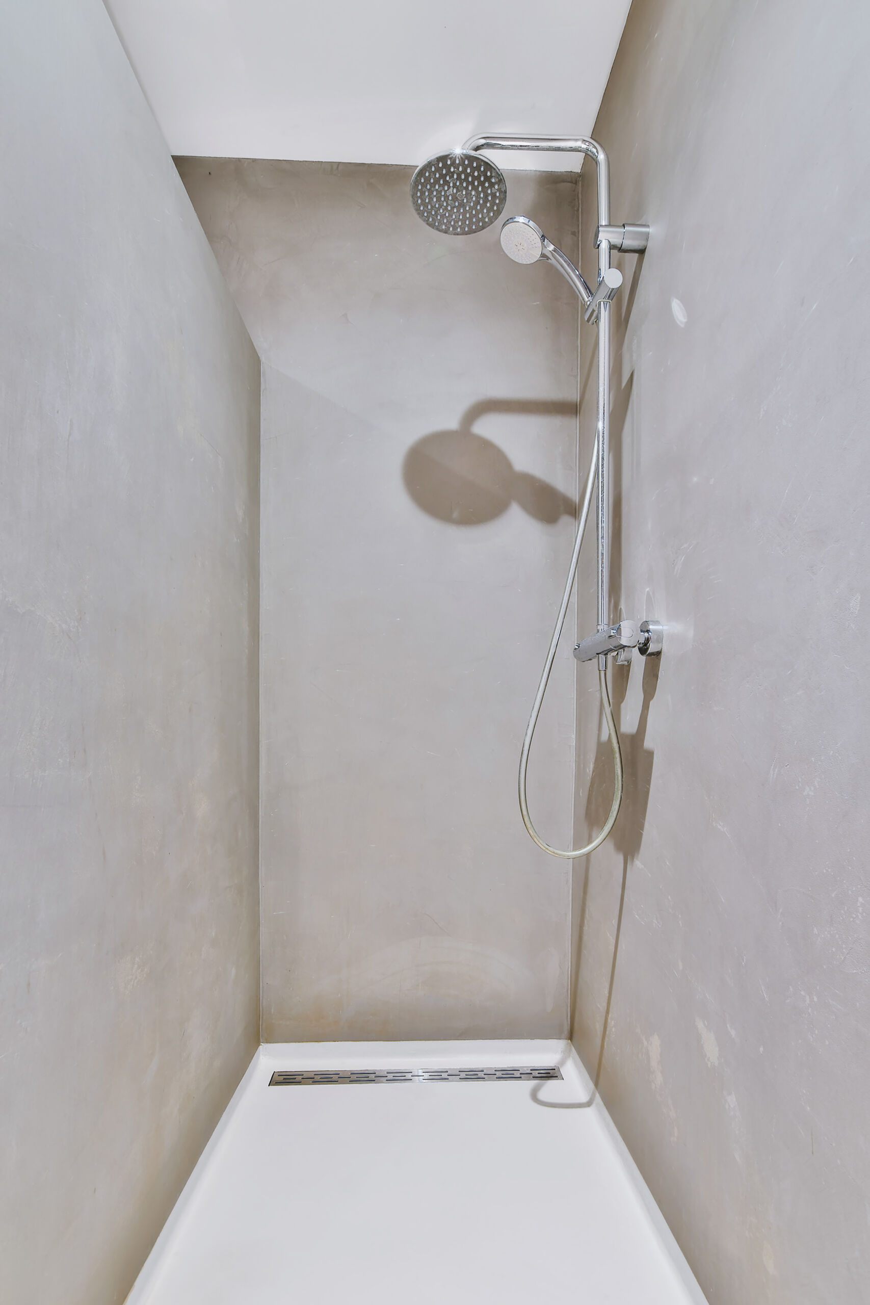 microcement-walls-floors-shower-over-tile-seamless-woodbridge-toronto Full bathroom view of microcement walls and floors; seamless application installed directly over existing tiles in the shower in the St. Clair area.