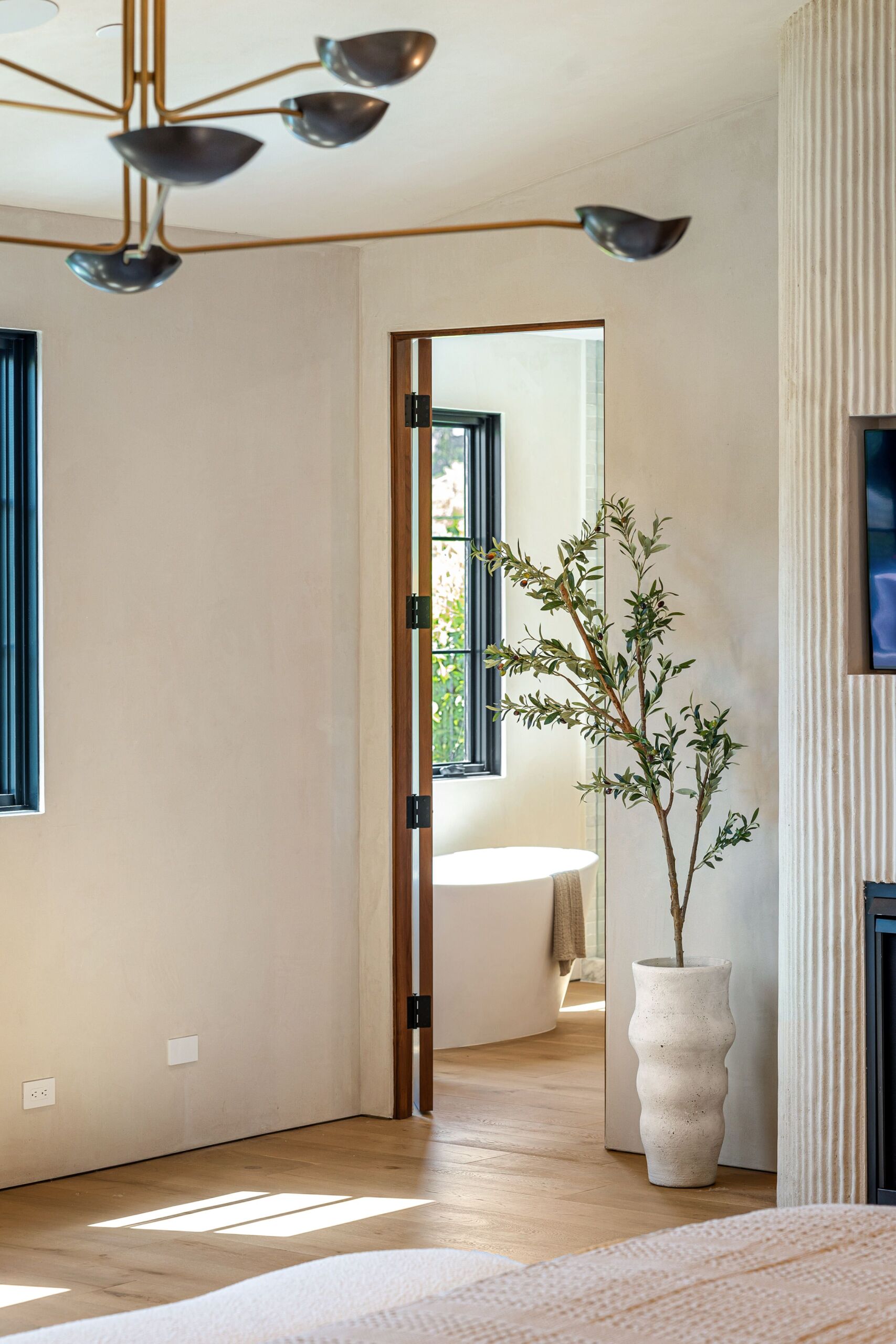 Modern minimalist interior with textured wall finished in fine marmorino plaster. Organic Wall Texture Ideas for family room: Bone colour plaster over fluted panelling.