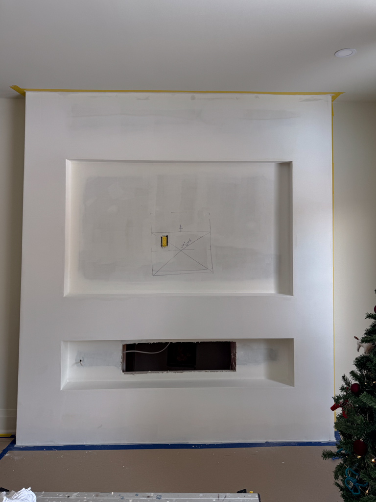 Unfinished drywall fireplace structure before being surfaced with decorative Venetian plaster.