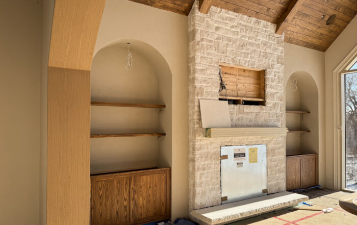 Custom Built-in Media Wall and Stone Fireplace after Microcement Application