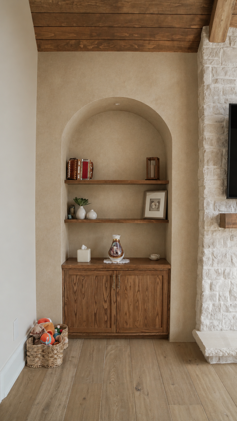 microcement-media-unit-curved-niches-adjacent-to-masonary-fireplace-in-grand-room-kleinurg2 Microcement media unit seamlessly connected to an adjacent stone fireplace in a luxury Kleinburg home