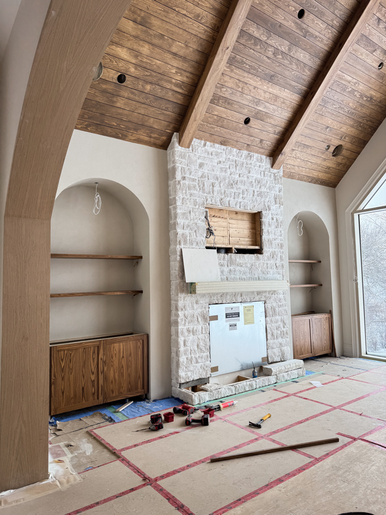 Custom great room featuring pine wood shiplap ceilings in a rich walnut stain, perfectly color-matched to modern built-in cabinetry of a media wall finished in microcement Kleinburg, Toronto.