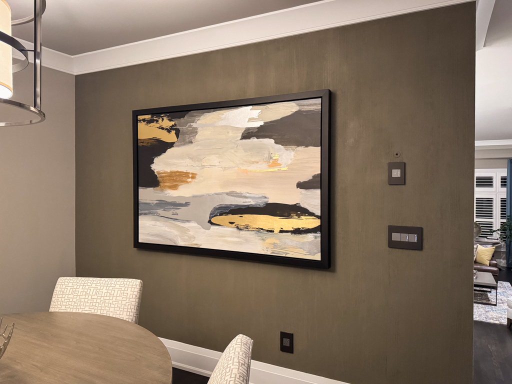 A finished Etobicoke dining room feature wall with a seamless, floor-to-ceiling bamboo-textured microcement finish in a soft, matte stone tone.