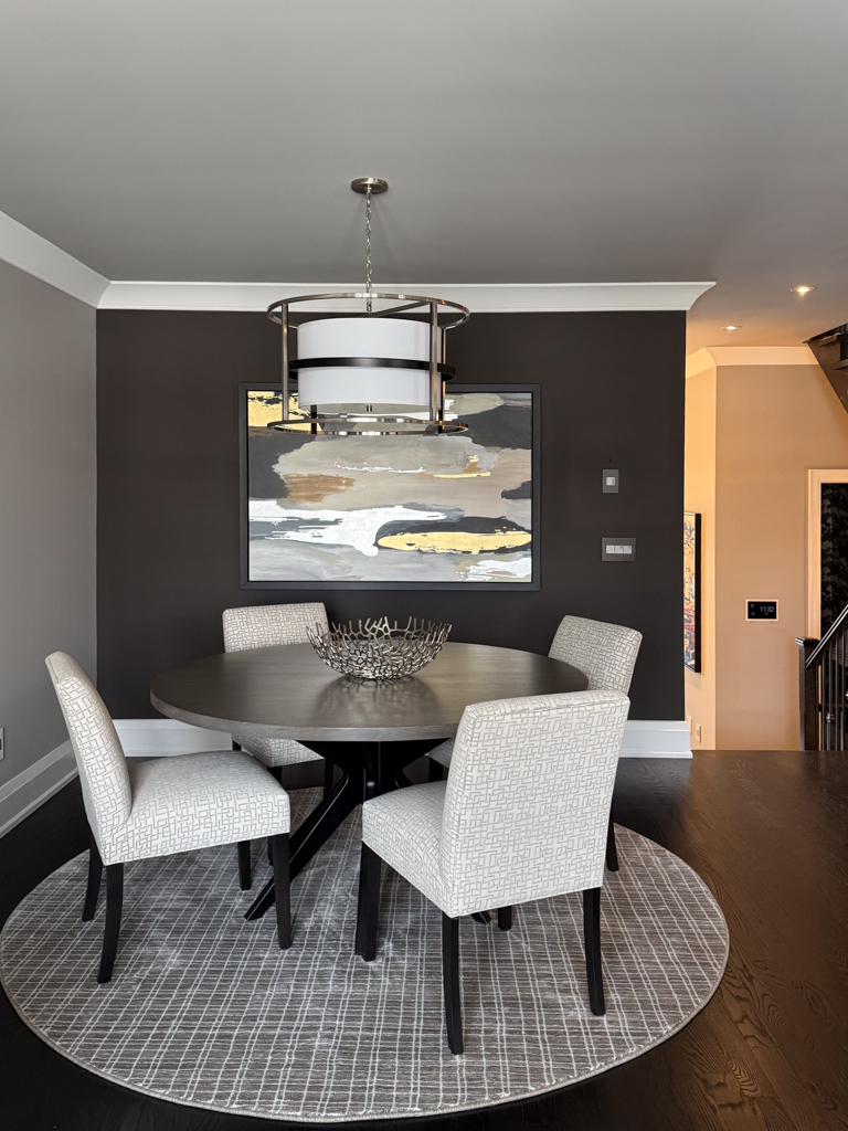 bamboo-design-microcement-walls-living-room-in-etobicoke-4 A bare drywall feature wall in an Etobicoke home prepared with blue painter's tape and floor protection before microcement application.