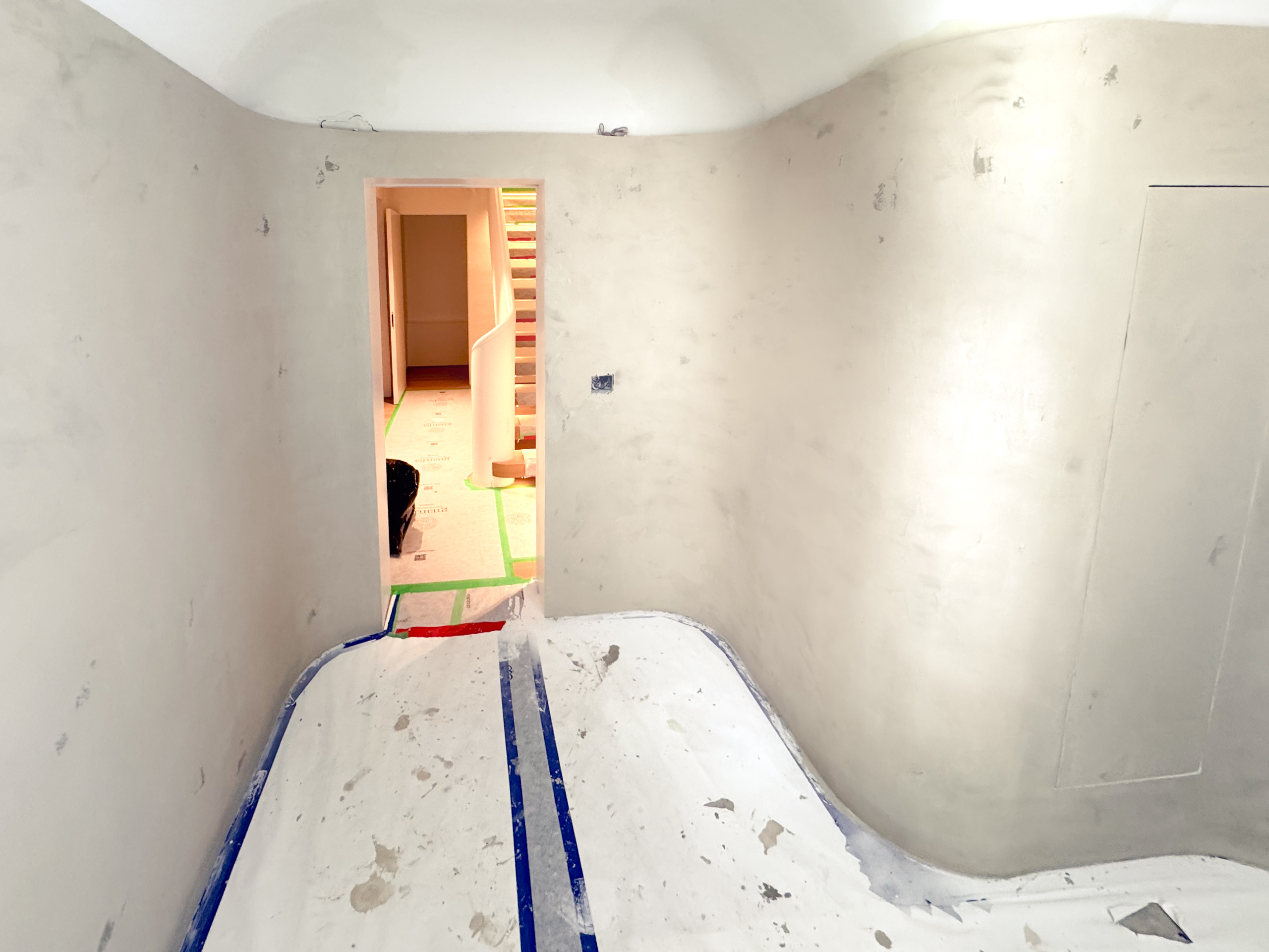 A contemporary home spa in Castle Frank, Toronto, featuring seamless soft grey microcement applied to the walls, closet doors, and a built-in vanity, finished with a matte, waterproof sealer.